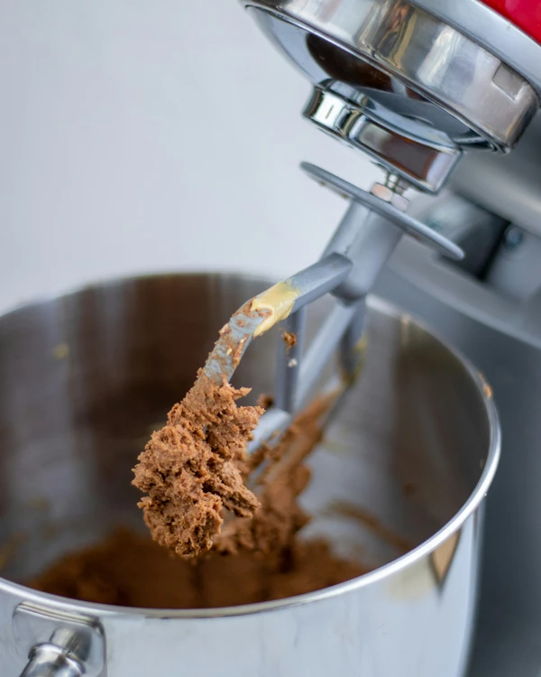 Fresh gourmet cookie dough mixed inside a professional stand mixer bowl