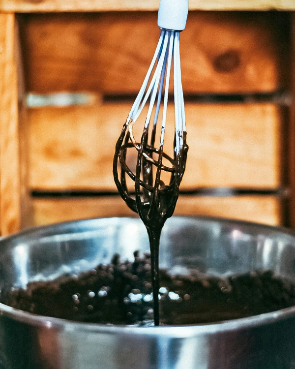 April mixing premium dark chocolate cookie dough by hand with a whisk